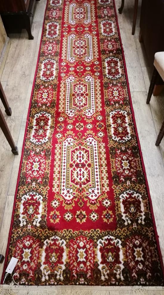 A Persian red ground runner 340 x 80cm